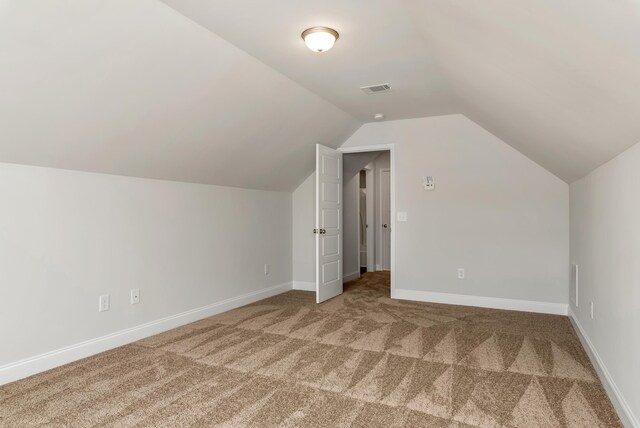 bonus room featuring carpet floors and lofted ceiling