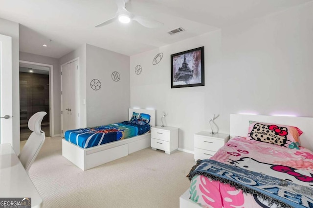 bedroom with visible vents, baseboards, light colored carpet, and a ceiling fan