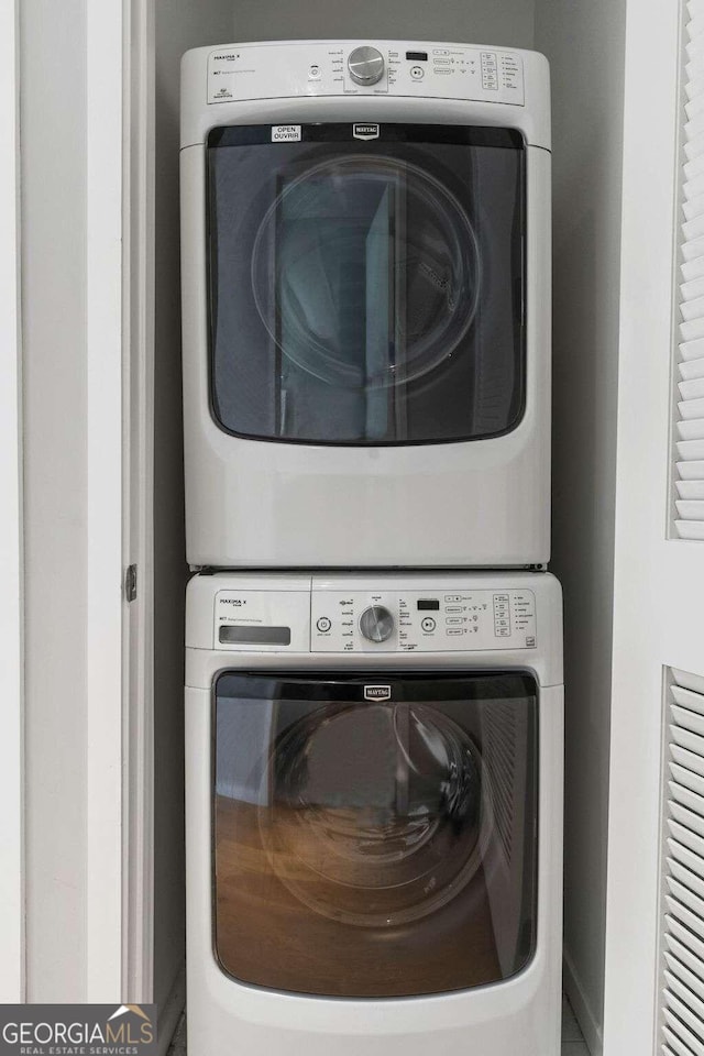 laundry room with laundry area and stacked washer / dryer