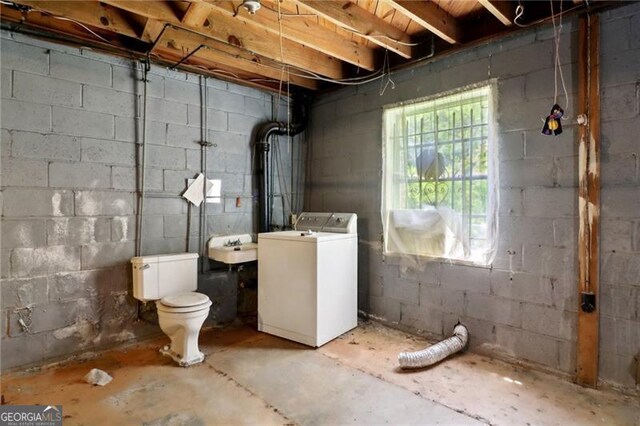 basement with a sink and washer / dryer