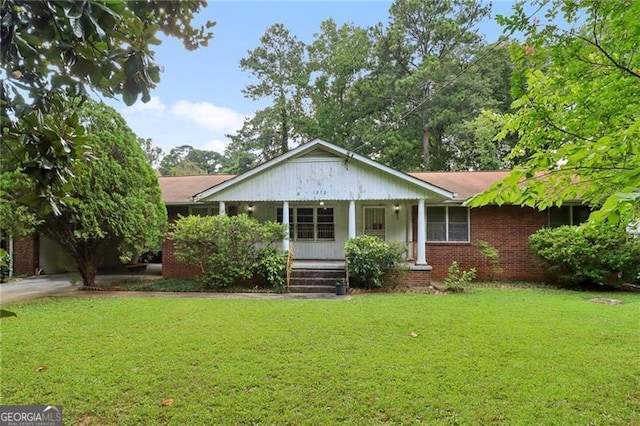 single story home featuring a front lawn and covered porch