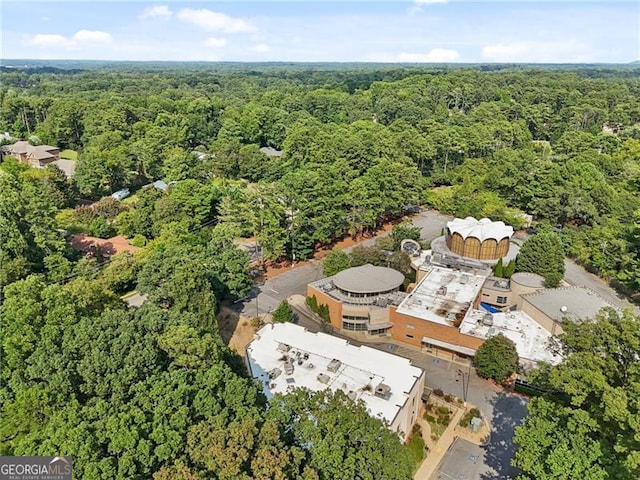 drone / aerial view with a wooded view