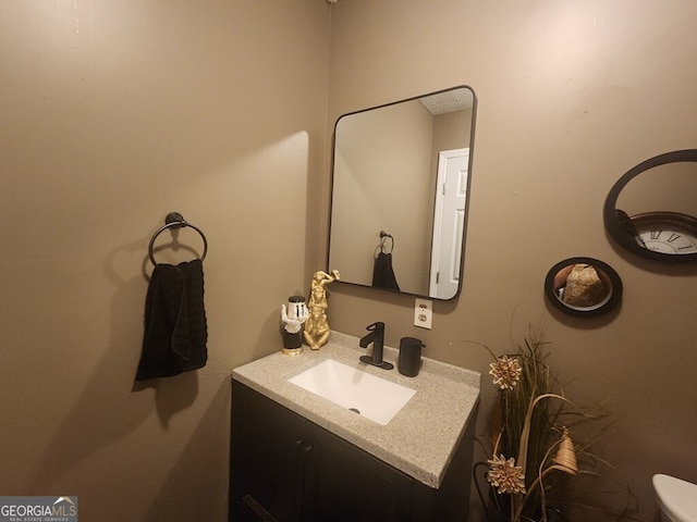 bathroom with toilet and vanity