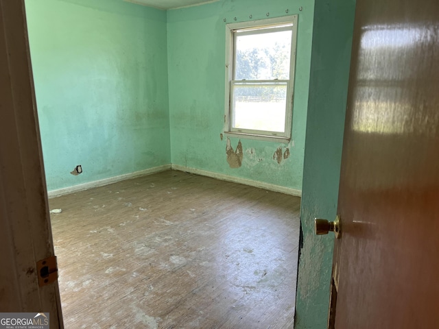 empty room with wood-type flooring