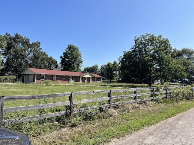 view of yard with a rural view