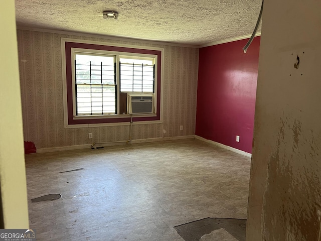 unfurnished room with a textured ceiling and cooling unit