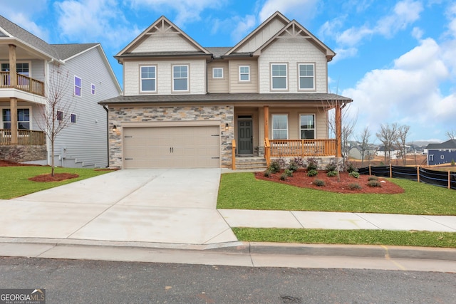 craftsman-style home with a front lawn, covered porch, and a garage