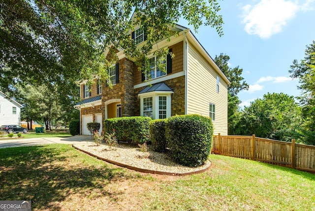 view of front of house featuring a front lawn and a garage