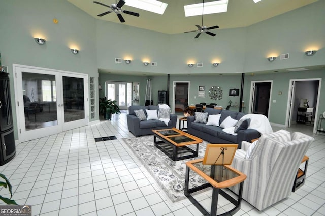 living area with a skylight, french doors, visible vents, and light tile patterned floors