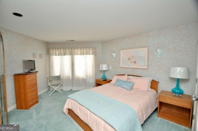 carpeted bedroom with wallpapered walls and baseboards