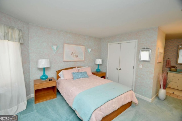 carpeted bedroom featuring a closet, baseboards, and wallpapered walls