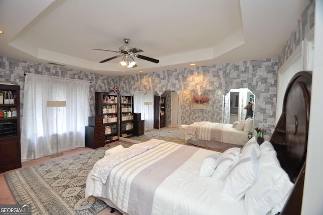 bedroom with recessed lighting, a raised ceiling, ceiling fan, and wallpapered walls