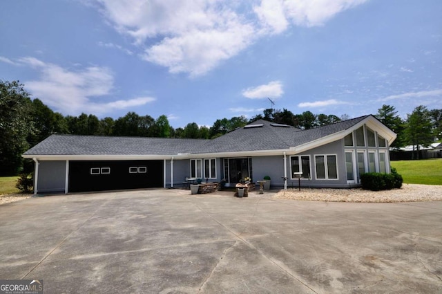 view of front of home with concrete driveway, an attached garage, and stucco siding