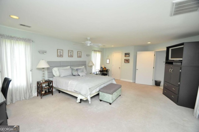 bedroom with light colored carpet, visible vents, ceiling fan, and recessed lighting