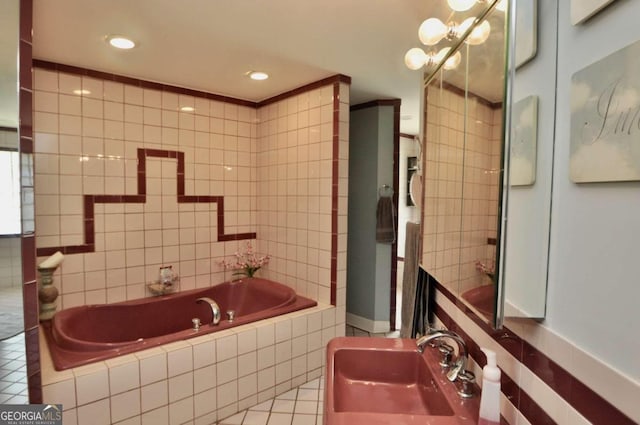 bathroom with recessed lighting, a sink, tile walls, a bath, and tile patterned floors