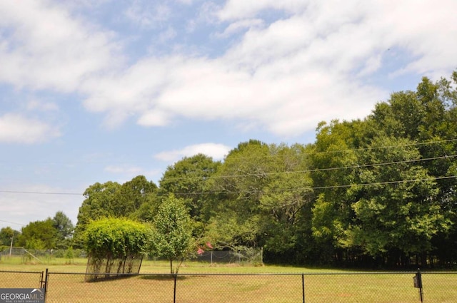 view of community featuring fence