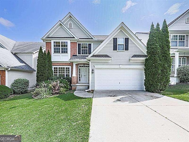 view of front of home with a front yard and a garage