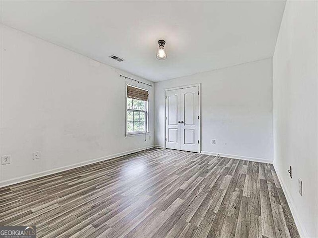 unfurnished room featuring hardwood / wood-style flooring