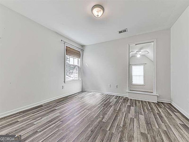 empty room featuring ceiling fan and hardwood / wood-style floors