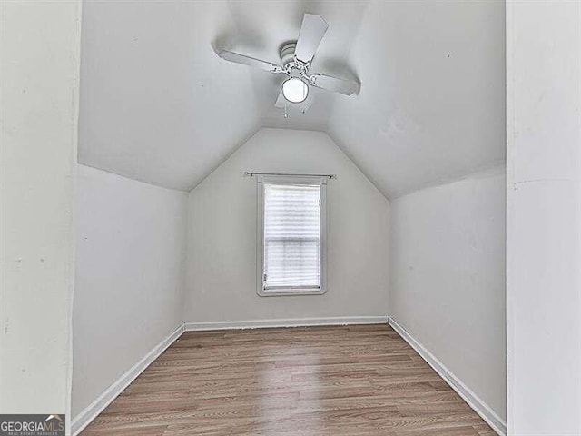 bonus room featuring ceiling fan, hardwood / wood-style floors, and lofted ceiling