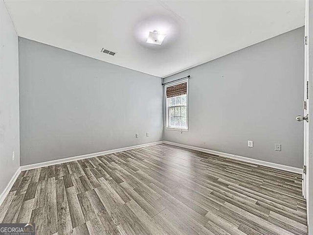 unfurnished room featuring hardwood / wood-style floors