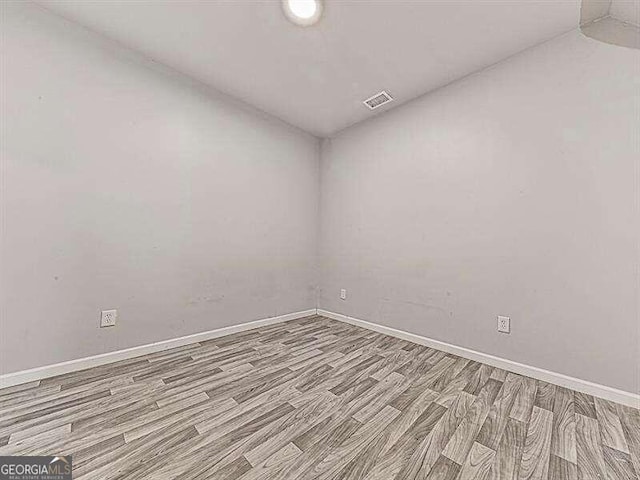 unfurnished room with light hardwood / wood-style floors