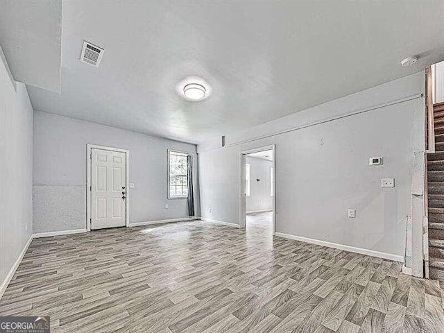 empty room with light hardwood / wood-style floors