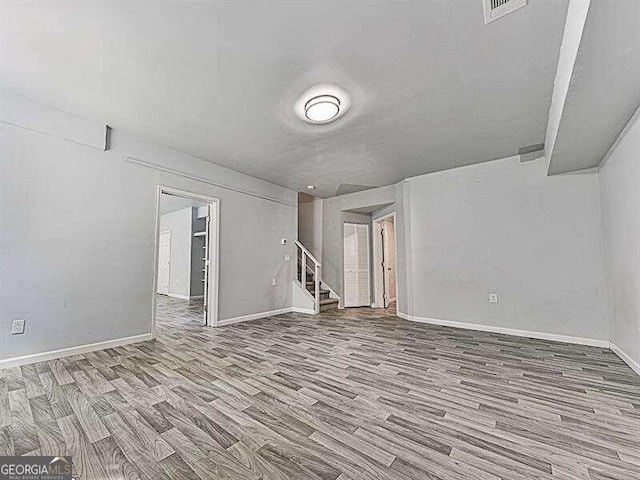 spare room featuring wood-type flooring