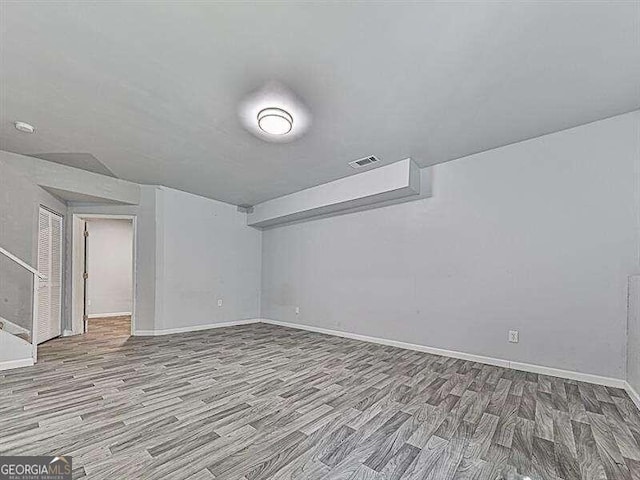 unfurnished room with hardwood / wood-style flooring