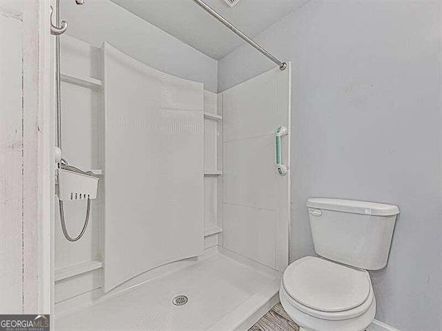 bathroom featuring toilet and a shower