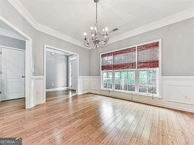 interior space featuring light hardwood / wood-style floors, an inviting chandelier, and ornamental molding