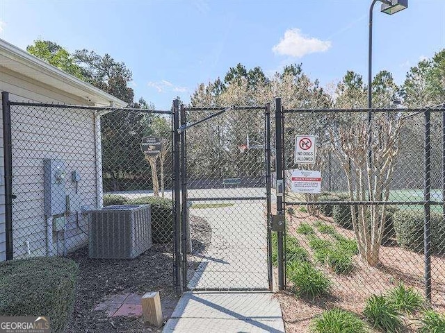 view of gate with central air condition unit