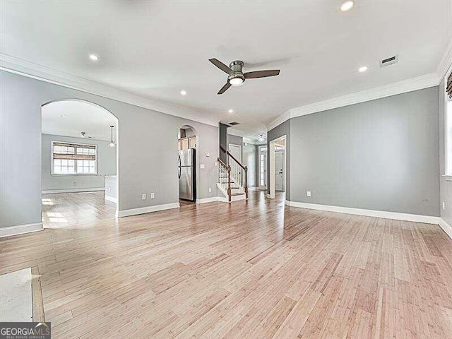 empty room featuring ceiling fan, light hardwood / wood-style flooring, and ornamental molding