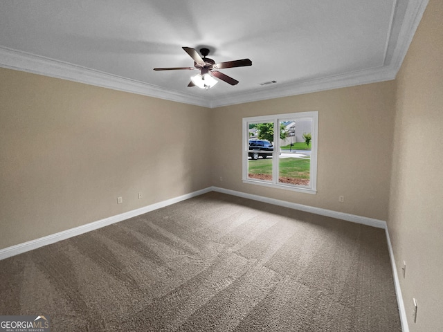 carpeted spare room featuring a ceiling fan, visible vents, crown molding, and baseboards