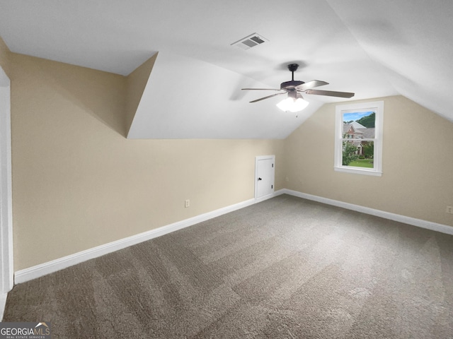 additional living space featuring carpet floors, baseboards, and vaulted ceiling