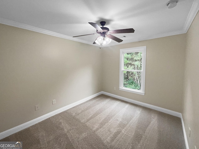 carpeted empty room featuring baseboards and ornamental molding