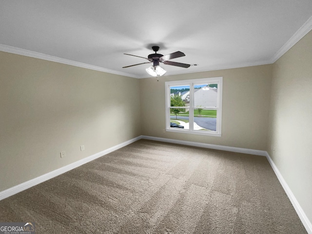 empty room with carpet floors, ornamental molding, a ceiling fan, and baseboards