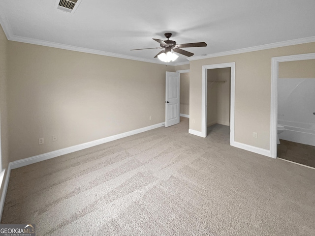 unfurnished bedroom with visible vents, baseboards, a closet, carpet, and crown molding