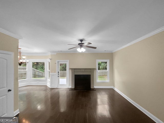 unfurnished living room with ceiling fan with notable chandelier, hardwood / wood-style flooring, and ornamental molding