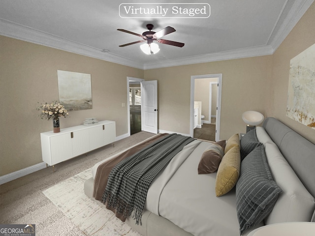 carpeted bedroom with ornamental molding, ceiling fan, baseboards, and ensuite bathroom