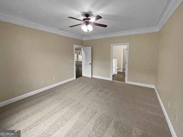 unfurnished bedroom featuring ornamental molding, carpet flooring, baseboards, and ensuite bathroom