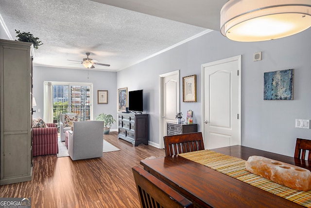 dining space featuring ceiling fan, dark hardwood / wood-style floors, and a textured ceiling