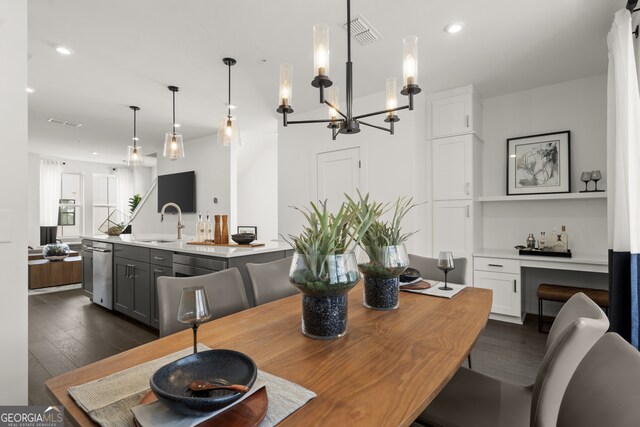 dining room featuring sink and dark hardwood / wood-style floors