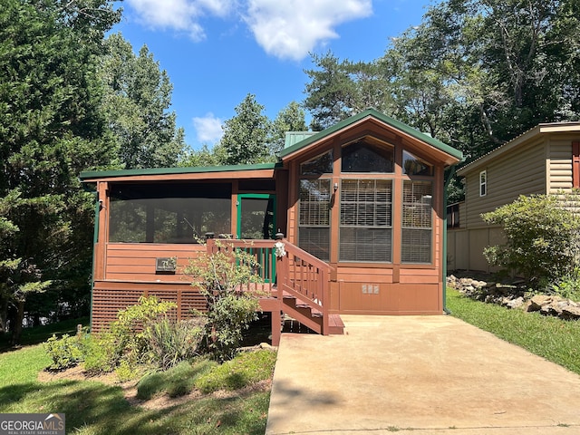 view of front of home with a sunroom