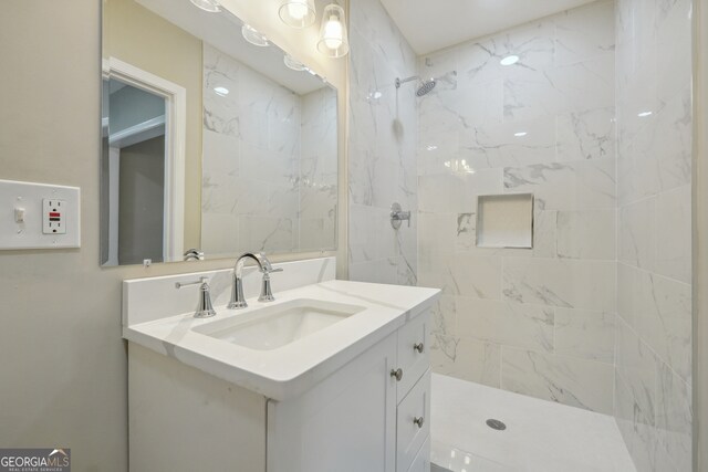 bathroom featuring vanity and tiled shower