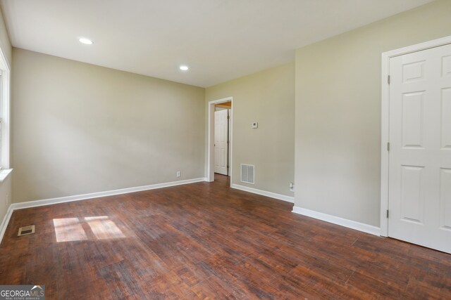 empty room with hardwood / wood-style flooring