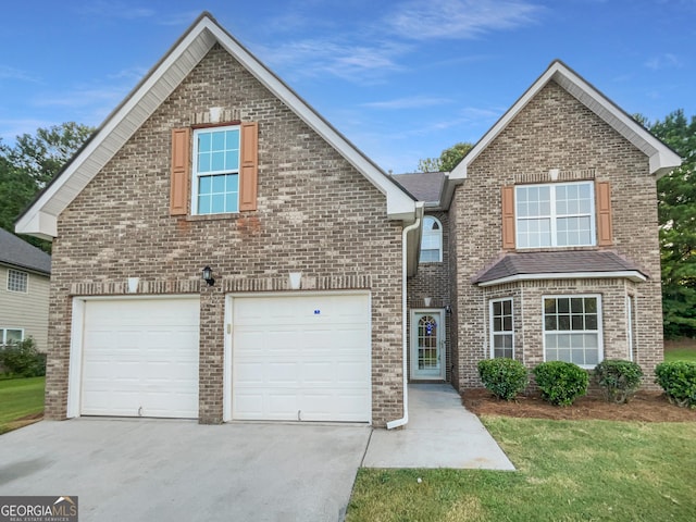 traditional-style home featuring a garage, driveway, and brick siding