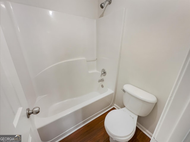 full bath with toilet, baseboards,  shower combination, and wood finished floors