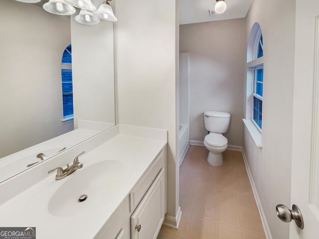 full bath featuring a bathtub, toilet, vanity, baseboards, and walk in shower