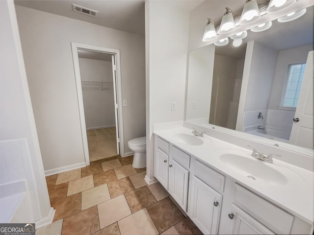 bathroom with a bath, double vanity, a sink, and visible vents